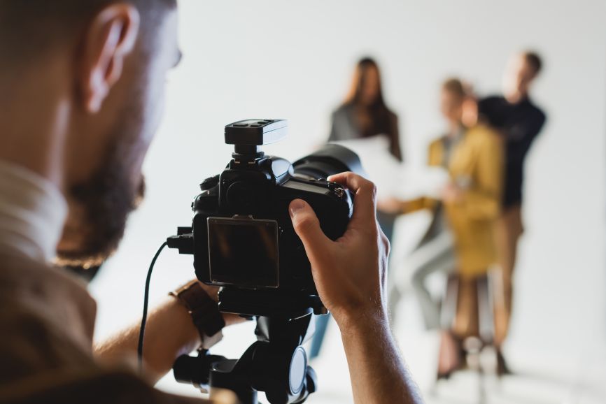 tv commercial production cost rises with crew, camera, and studio setup